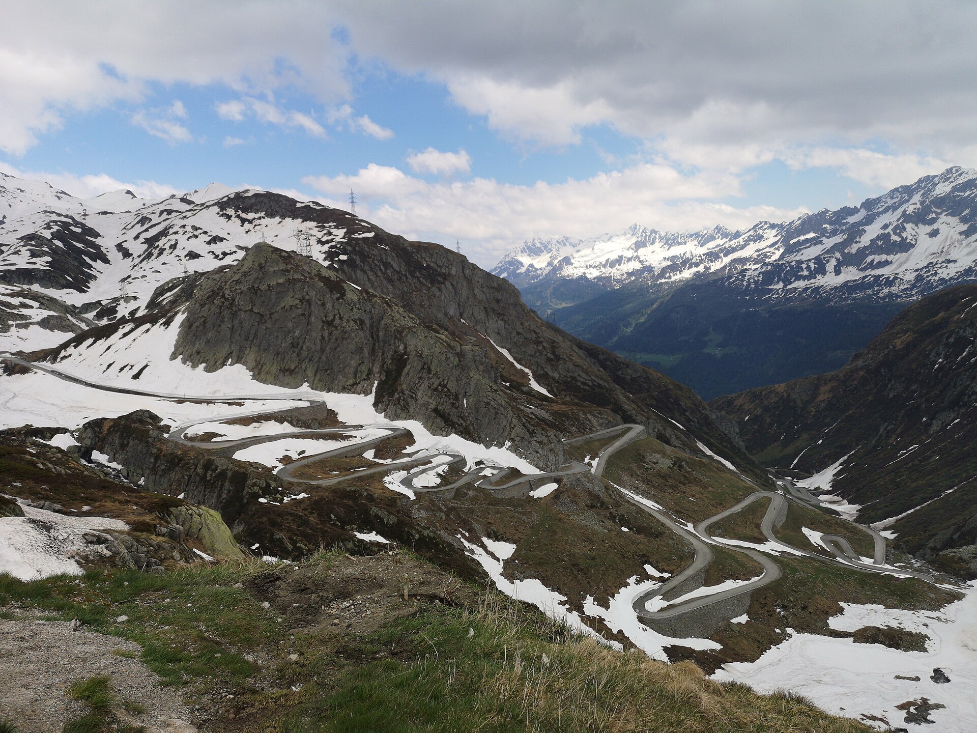 The switchback road over the Gotthard Pass in the Swiss Alps, engineered in tight hairpins across a steep slope.